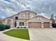 Exterior view of a beautiful two-story home with a three car garage and well-manicured lawn at 5545 E Helena Dr, Scottsdale, AZ 85254