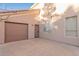 Exterior view shows a two-car garage and neutral stucco siding, complemented by a well-maintained yard at 5545 E Helena Dr, Scottsdale, AZ 85254