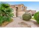 Charming two-story home featuring a tile roof and stucco exterior with desert landscaping and mature shrubbery at 5545 E Helena Dr, Scottsdale, AZ 85254