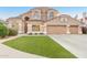 Charming two-story home featuring a tile roof, stucco exterior, well-manicured lawn, and a two-car garage at 5545 E Helena Dr, Scottsdale, AZ 85254