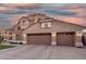 Charming two-story home featuring a tile roof, stucco exterior, well-manicured lawn, and a two-car garage at 5545 E Helena Dr, Scottsdale, AZ 85254