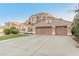 Elegant two-story home featuring a three-car garage and well-maintained landscaping at 5545 E Helena Dr, Scottsdale, AZ 85254