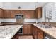 Well-equipped kitchen with stainless steel appliances and granite countertops at 5545 E Helena Dr, Scottsdale, AZ 85254