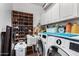 Well-organized laundry room with washer, dryer, shoe rack and white cabinets offers ample storage space at 5545 E Helena Dr, Scottsdale, AZ 85254