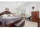 Bright main bedroom with carpet, ceiling fan, and shuttered windows, creating a tranquil retreat at 5545 E Helena Dr, Scottsdale, AZ 85254