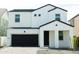 Modern two-story home showcasing a black garage door and white facade at 5826 S Daisy Patch Pl, Phoenix, AZ 85040