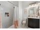 Bright bathroom showcasing a shower-tub combo with white subway tile, niche, and a dark wood vanity with mosaic mirror at 5904 E Calle De Las Estrellas Rd, Cave Creek, AZ 85331