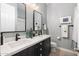 Spacious bathroom with a double vanity, sleek black fixtures, and modern lighting providing a clean and functional design at 5904 E Calle De Las Estrellas Rd, Cave Creek, AZ 85331