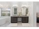 Bathroom featuring dual sinks, marble floors, freestanding tub, and decorative chandelier at 5904 E Calle De Las Estrellas Rd, Cave Creek, AZ 85331