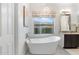 Bathroom featuring a freestanding tub, decorative chandelier and window view at 5904 E Calle De Las Estrellas Rd, Cave Creek, AZ 85331