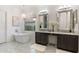 Luxurious bathroom featuring a soaking tub, double vanity, and elegant lighting fixtures at 5904 E Calle De Las Estrellas Rd, Cave Creek, AZ 85331