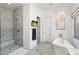 Bathroom featuring a glass enclosed shower, freestanding tub, marble floors, and television at 5904 E Calle De Las Estrellas Rd, Cave Creek, AZ 85331