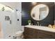 Modern bathroom featuring black shiplap accent wall, stylish vanity, and a glass enclosed shower at 5904 E Calle De Las Estrellas Rd, Cave Creek, AZ 85331