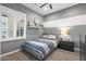 Cozy bedroom featuring horizontal gray and white stripes, a comfortable bed, and window with plantation shutters at 5904 E Calle De Las Estrellas Rd, Cave Creek, AZ 85331