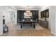 Dining room featuring a decorative light fixture, black accent wall with painting, and table with 6 chairs and a bench at 5904 E Calle De Las Estrellas Rd, Cave Creek, AZ 85331