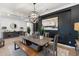 Dining room featuring a decorative light fixture, black accent wall with painting, and table with 6 chairs and a bench at 5904 E Calle De Las Estrellas Rd, Cave Creek, AZ 85331