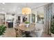 Open-concept dining room with a decorative light fixture, wood table, stylish chairs and a large window at 5904 E Calle De Las Estrellas Rd, Cave Creek, AZ 85331