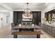 Dining room featuring a decorative light fixture, black accent wall with painting, and table with 6 chairs and a bench at 5904 E Calle De Las Estrellas Rd, Cave Creek, AZ 85331