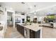 Spacious kitchen island features stainless steel sink, granite countertop and is open to the adjacent living area at 5904 E Calle De Las Estrellas Rd, Cave Creek, AZ 85331