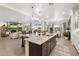 Spacious kitchen island with stainless steel sink and seating area open to the living room and dining area at 5904 E Calle De Las Estrellas Rd, Cave Creek, AZ 85331