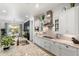 Well-lit kitchen with white cabinets, stainless steel appliances, and granite countertops that complement the modern design at 5904 E Calle De Las Estrellas Rd, Cave Creek, AZ 85331