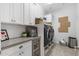 Well-equipped laundry room with white cabinets, a beverage cooler, and modern appliances at 5904 E Calle De Las Estrellas Rd, Cave Creek, AZ 85331