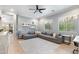 Comfortable living room featuring a large gray sectional sofa, modern fan and neutral color palette at 5904 E Calle De Las Estrellas Rd, Cave Creek, AZ 85331