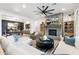 Open concept living room featuring a brick fireplace, a large sectional sofa, a ceiling fan and views to the backyard at 5904 E Calle De Las Estrellas Rd, Cave Creek, AZ 85331