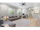 Comfortable living room featuring a large gray sectional sofa, modern fan and neutral color palette at 5904 E Calle De Las Estrellas Rd, Cave Creek, AZ 85331