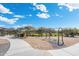 Community playground with swings, sand base, bike racks and walkway surrounded by lush landscaping under a sunny sky at 5904 E Calle De Las Estrellas Rd, Cave Creek, AZ 85331