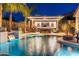 Luxurious pool and outdoor kitchen area with a built-in grill and seating at 5904 E Calle De Las Estrellas Rd, Cave Creek, AZ 85331