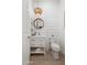 Bright powder room with shiplap walls, marble countertop, and modern light fixture at 5904 E Calle De Las Estrellas Rd, Cave Creek, AZ 85331