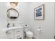 Powder room featuring shiplap wall, round mirror, and marble countertop at 5904 E Calle De Las Estrellas Rd, Cave Creek, AZ 85331