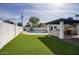 Spacious backyard featuring an outdoor kitchen, a well-maintained lawn, and a sparkling pool at 6325 N 83Rd Pl, Scottsdale, AZ 85250