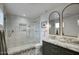 Modern bathroom with elegant vanity, sleek tile floors, and a large glass shower at 6325 N 83Rd Pl, Scottsdale, AZ 85250