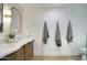 Charming bathroom featuring double sinks, elegant mirrors, and a luxurious walk in shower at 6325 N 83Rd Pl, Scottsdale, AZ 85250