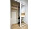 Bedroom closet with mirrored sliding door and built-in shelving and desk space at 6325 N 83Rd Pl, Scottsdale, AZ 85250