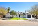 Charming single-story home featuring a well-manicured lawn and desert landscaping at 6325 N 83Rd Pl, Scottsdale, AZ 85250