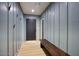 Inviting hallway featuring stylish wainscoting and a convenient bench for added functionality at 6325 N 83Rd Pl, Scottsdale, AZ 85250