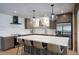 Modern kitchen featuring stainless steel appliances, a large island, and stylish pendant lighting at 6325 N 83Rd Pl, Scottsdale, AZ 85250