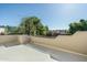 Balcony with low stucco wall offers partial views of neighborhood landscaping at 6711 E Camelback Rd # 43, Scottsdale, AZ 85251