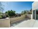 Balcony with low stucco wall offers treetop views of neighborhood at 6711 E Camelback Rd # 43, Scottsdale, AZ 85251