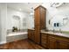 Main bathroom with double vanity, soaking tub, and wooden cabinets at 6711 E Camelback Rd # 43, Scottsdale, AZ 85251