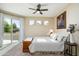 Bedroom with a private balcony, ceiling fan, and three smaller windows at 6711 E Camelback Rd # 43, Scottsdale, AZ 85251