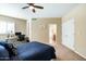 Large bedroom features carpet, ceiling fan, and a view into an en suite bathroom at 6711 E Camelback Rd # 43, Scottsdale, AZ 85251