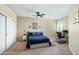 Bedroom featuring a ceiling fan, carpeted floors, and a large window with natural light at 6711 E Camelback Rd # 43, Scottsdale, AZ 85251