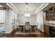 Dining area with hardwood floors, modern light fixture, and views of the outdoor patio at 6711 E Camelback Rd # 43, Scottsdale, AZ 85251