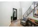 Bright foyer features decorative glass door, stone floors and staircase with wrought iron railing at 6711 E Camelback Rd # 43, Scottsdale, AZ 85251