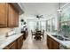 Well-lit kitchen with granite counters, wood cabinets, and bright breakfast nook at 6711 E Camelback Rd # 43, Scottsdale, AZ 85251