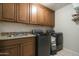 Functional laundry room with washer, dryer, cabinets, and utility sink at 6711 E Camelback Rd # 43, Scottsdale, AZ 85251